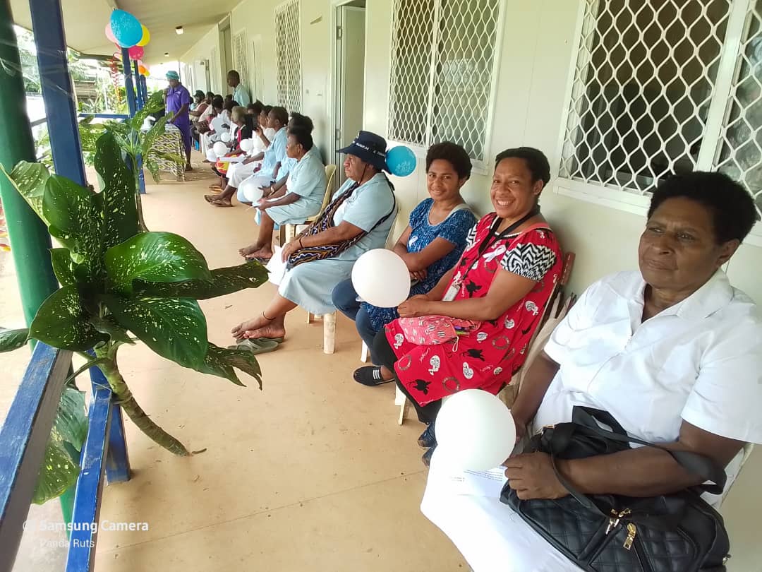 Expectant mothers and healthcare providers gather to celebrate the positive impact of our maternal health initiative. The pro