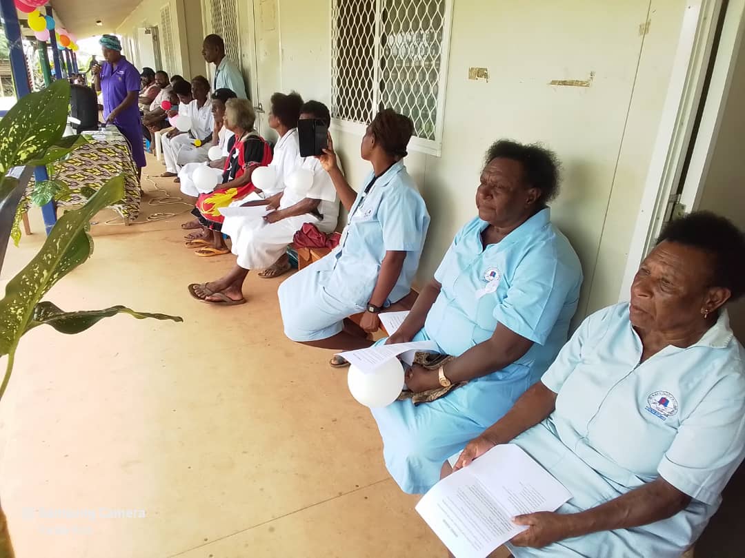 Healthcare workers gather for an event highlighting the positive impact of the maternal health initiative. The program aims t